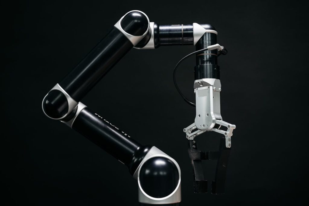 Close-up of a mechanical robotic arm with a dark background, showcasing advanced technology.